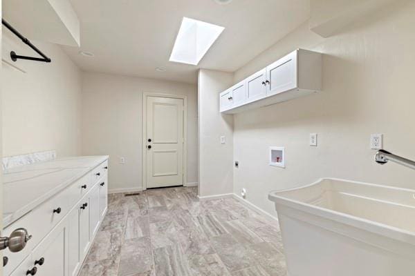 washroom with sink, cabinets, a skylight, hookup for a washing machine, and hookup for an electric dryer