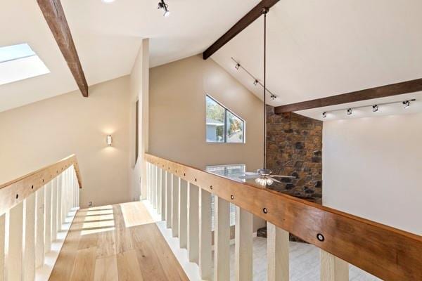 corridor with hardwood / wood-style flooring and lofted ceiling with beams