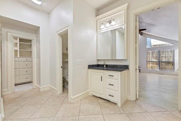 bathroom featuring vanity, tile patterned floors, and toilet