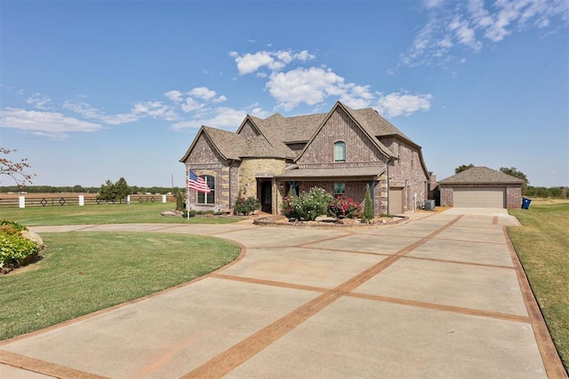 french country inspired facade featuring a front lawn and a garage