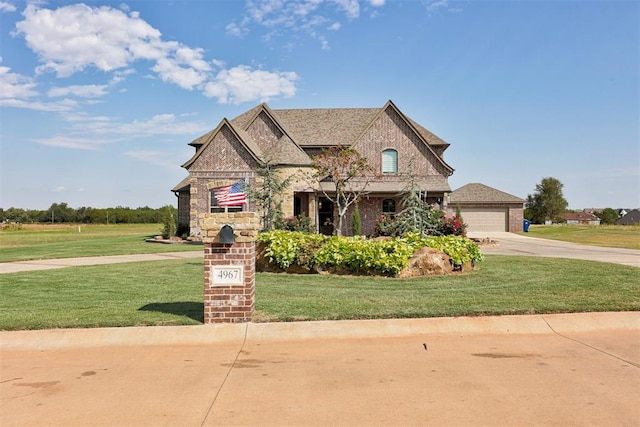 view of front of home featuring a garage and a front lawn