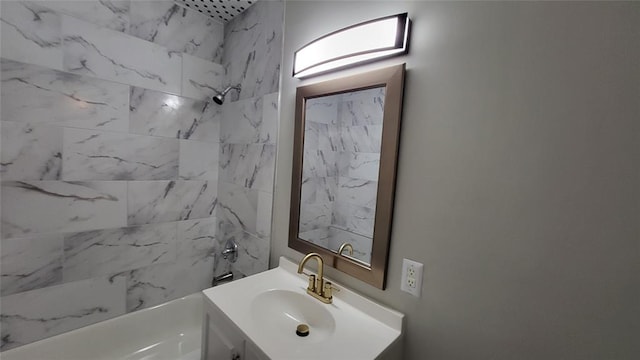 bathroom featuring vanity and tiled shower / bath combo