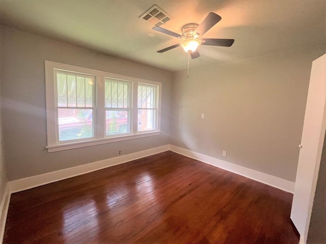 empty room featuring dark hardwood / wood-style floors and ceiling fan