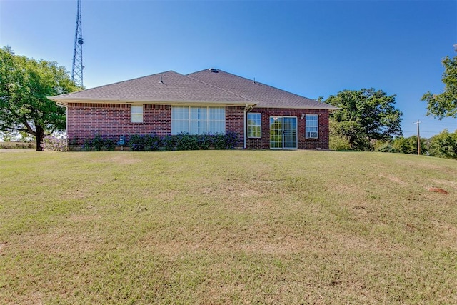 back of property featuring a lawn