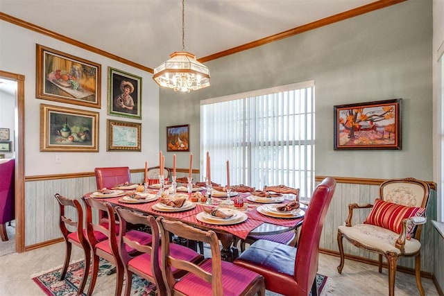 dining room featuring crown molding, wooden walls, and an inviting chandelier