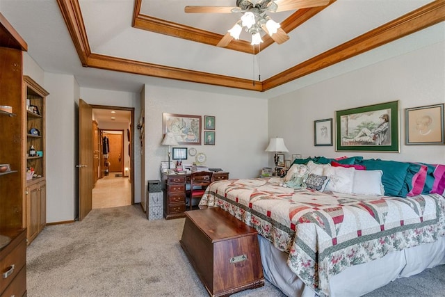 carpeted bedroom featuring ceiling fan, crown molding, and a tray ceiling