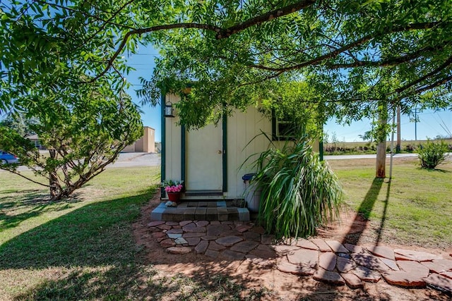 view of outdoor structure featuring a lawn