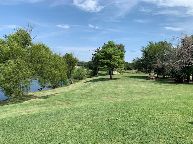 view of home's community featuring a yard and a water view