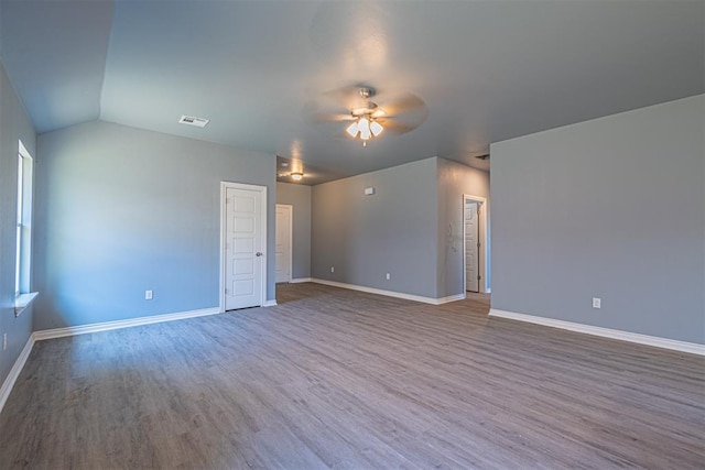 spare room featuring ceiling fan, wood-type flooring, and vaulted ceiling