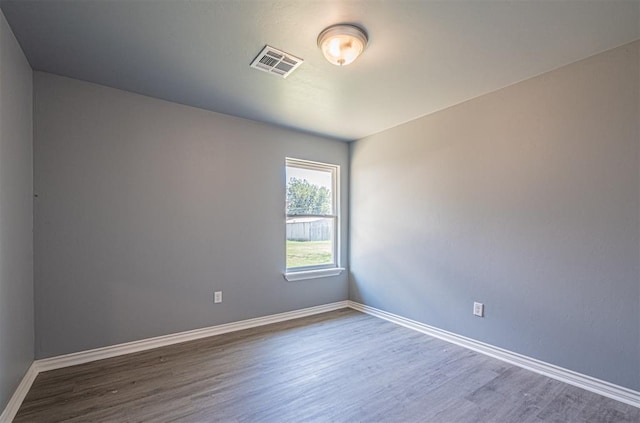 unfurnished room featuring dark hardwood / wood-style flooring