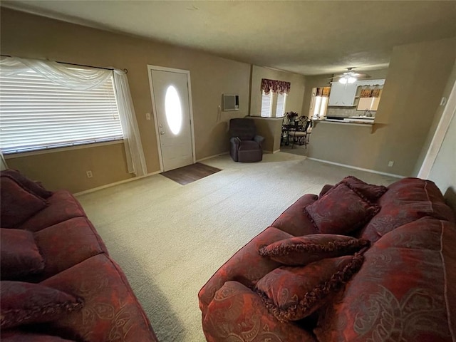 carpeted living room with ceiling fan