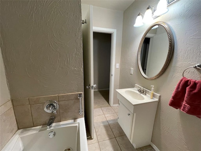 bathroom featuring tile patterned floors, a bathtub, and vanity