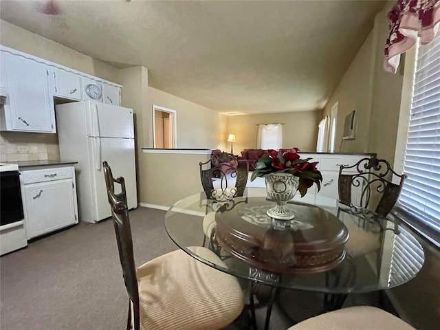 dining room featuring light colored carpet and plenty of natural light