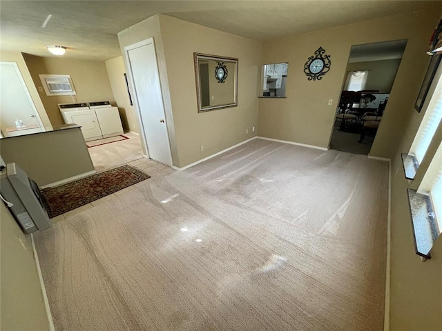 unfurnished dining area featuring light colored carpet and independent washer and dryer