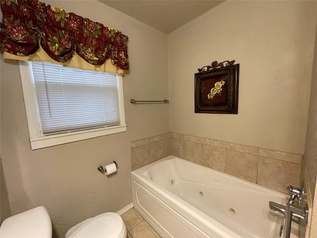 bathroom with a bathing tub, tile patterned flooring, and toilet