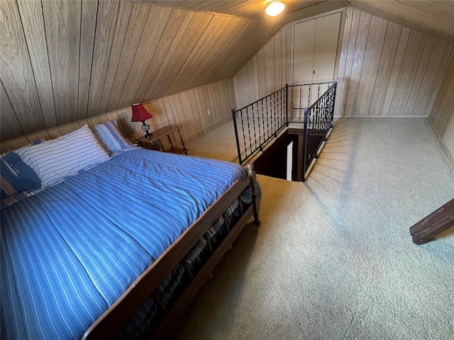 carpeted bedroom with wooden walls, wooden ceiling, and lofted ceiling