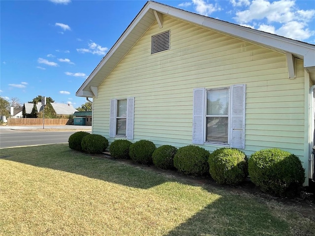 view of side of home featuring a lawn