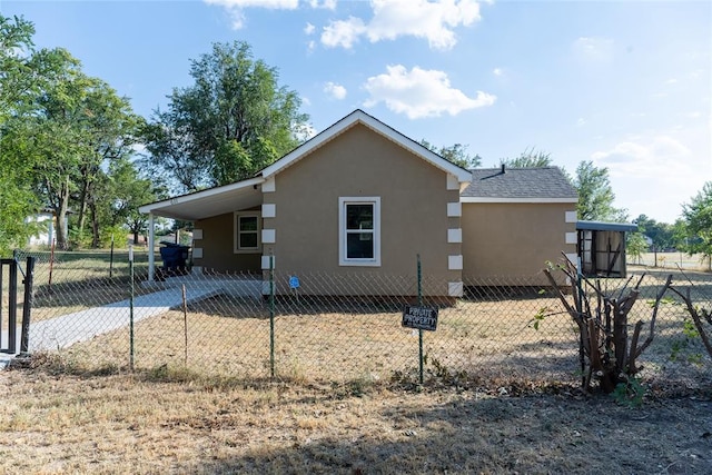 view of side of home with a carport