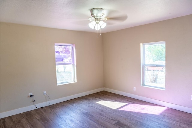 spare room featuring hardwood / wood-style floors, plenty of natural light, and ceiling fan