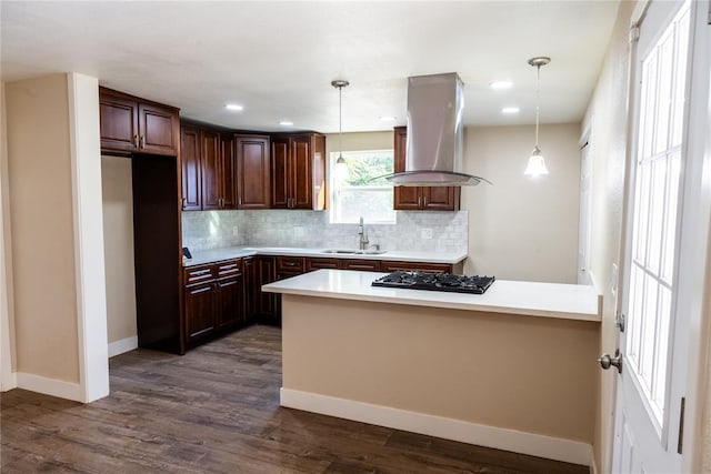 kitchen with island range hood, dark wood-type flooring, pendant lighting, and gas stovetop