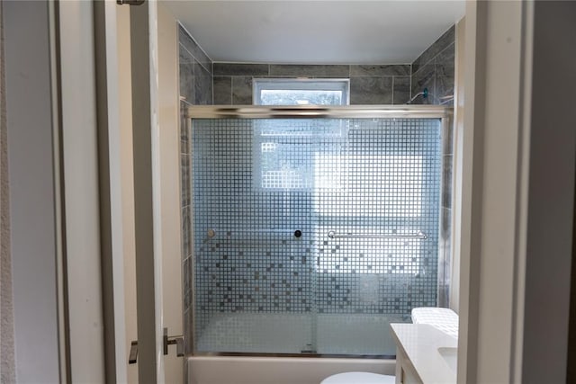 full bathroom featuring vanity, toilet, and enclosed tub / shower combo