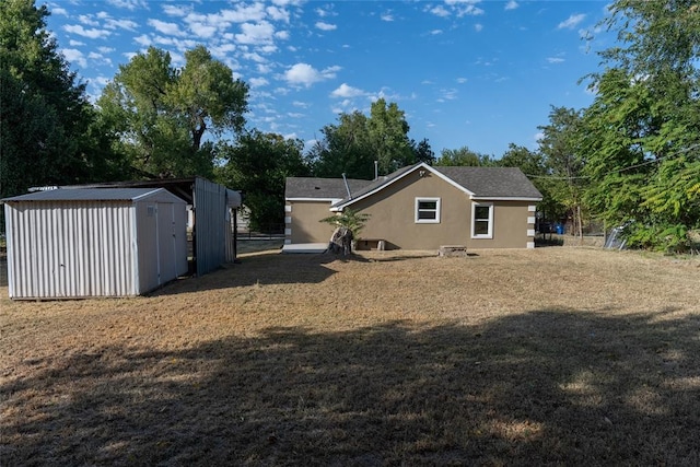 back of property with a storage shed