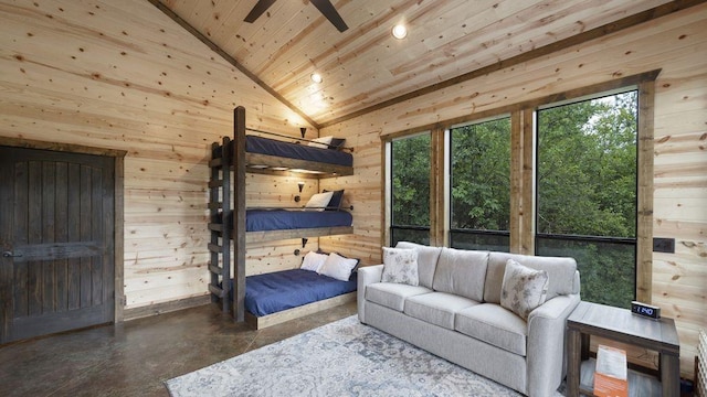 bedroom featuring wood walls, wood ceiling, high vaulted ceiling, and concrete floors