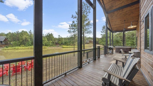 sunroom featuring a water view, wood ceiling, and vaulted ceiling