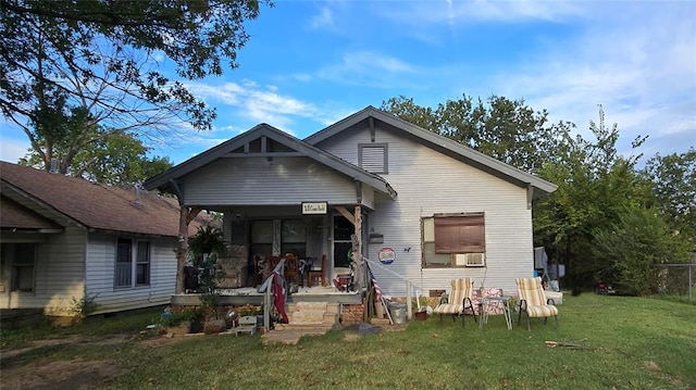 view of front facade with covered porch and a front yard