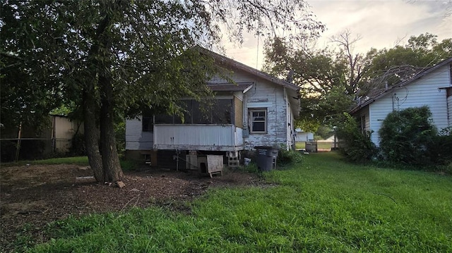 618 S Wewoka Ave, Wewoka, OK 74884 - back house at dusk featuring a yard