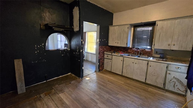 618 S Wewoka Ave, Wewoka, OK 74884 - kitchen with tasteful backsplash, sink, light brown cabinets, and light hardwood / wood-style flooring