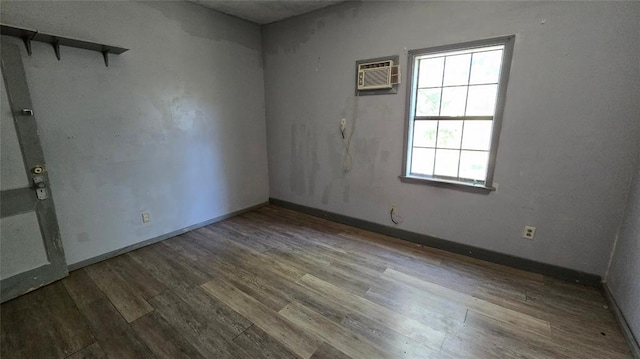 618 S Wewoka Ave, Wewoka, OK 74884 - spare room featuring wood-type flooring and a wall mounted AC