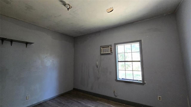 618 S Wewoka Ave, Wewoka, OK 74884 - unfurnished room with dark hardwood / wood-style flooring and an AC wall unit
