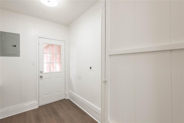 entryway featuring a textured ceiling, electric panel, dark hardwood / wood-style floors, and wooden walls