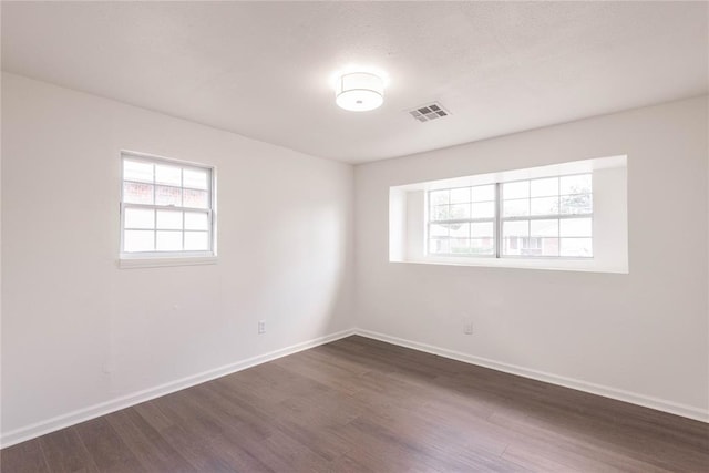 unfurnished room featuring dark wood-type flooring