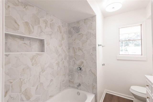 full bathroom featuring hardwood / wood-style flooring, vanity, toilet, and tiled shower / bath