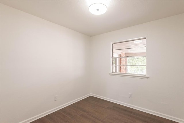 spare room with dark hardwood / wood-style floors