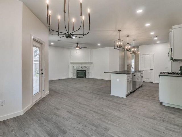 1213 SW 23rd St, Oklahoma City, OK 73109 - kitchen featuring a chandelier, dark countertops, ceiling fan, recessed lighting, and wood finished floors
