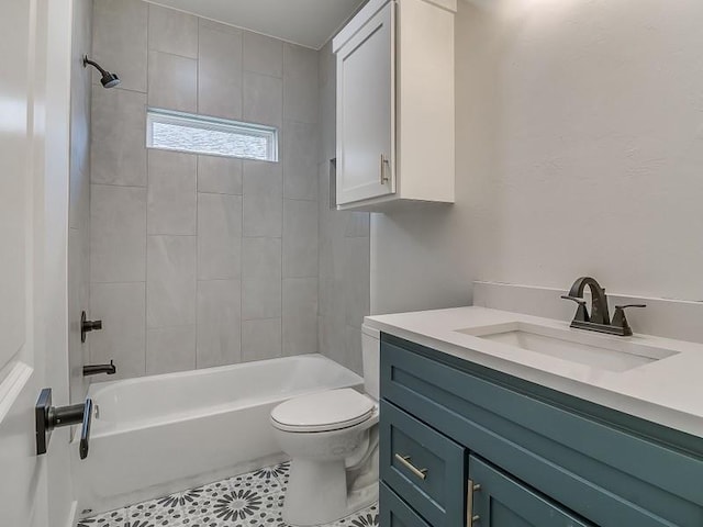 full bathroom with tile patterned flooring, vanity, tiled shower / bath combo, and toilet