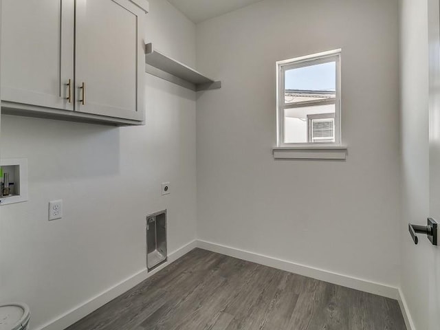 laundry room featuring electric dryer hookup, cabinets, dark hardwood / wood-style floors, and washer hookup