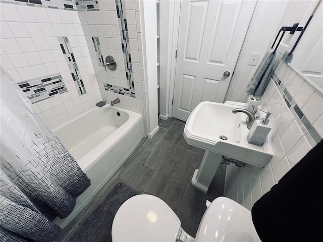 full bathroom with toilet, sink, shower / tub combo with curtain, and hardwood / wood-style flooring