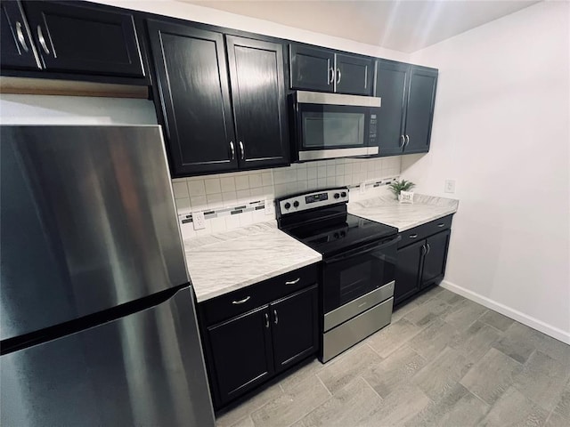 kitchen with appliances with stainless steel finishes and tasteful backsplash