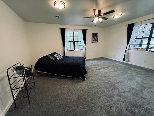 bedroom with ceiling fan and dark carpet