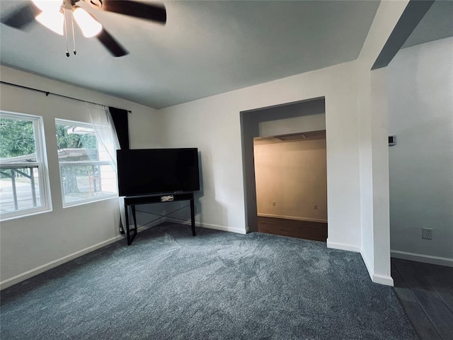 bedroom featuring dark colored carpet and ceiling fan