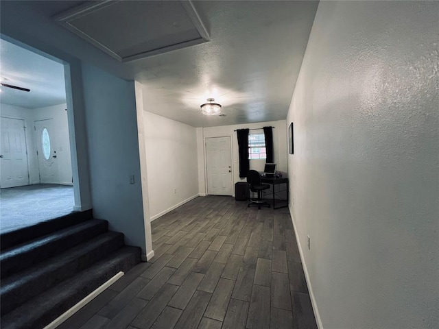 corridor with dark hardwood / wood-style flooring