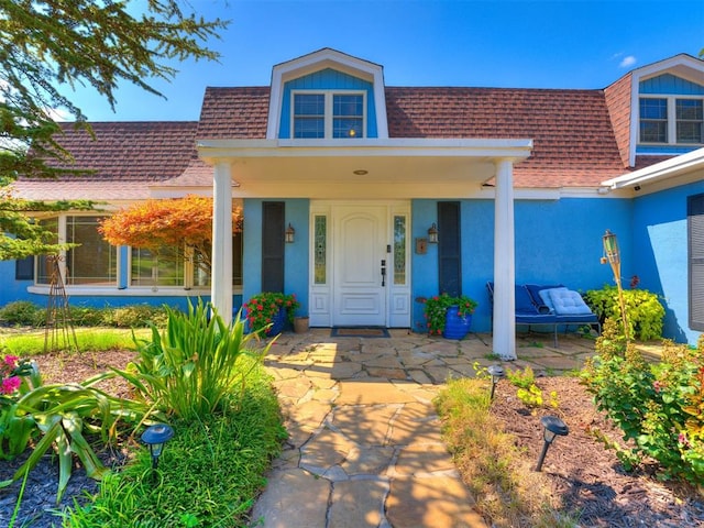 view of exterior entry featuring a porch