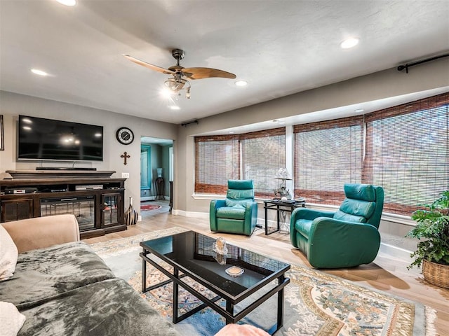 living room featuring light wood-type flooring and ceiling fan