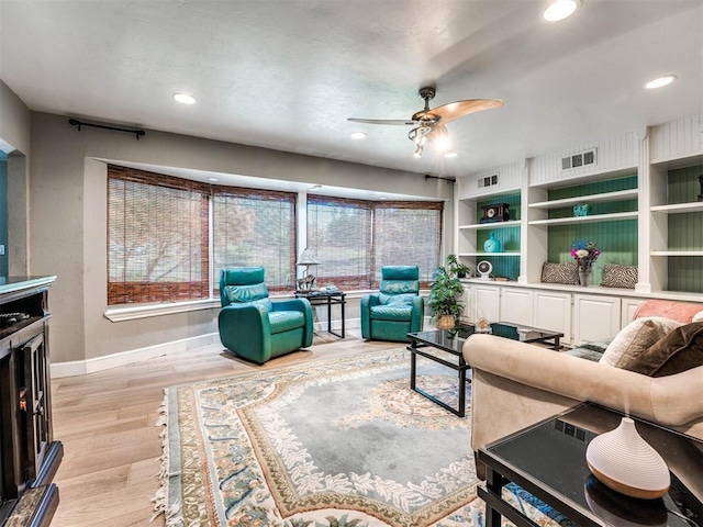 living room featuring ceiling fan and light wood-type flooring