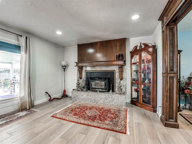 living room featuring light hardwood / wood-style floors and a textured ceiling