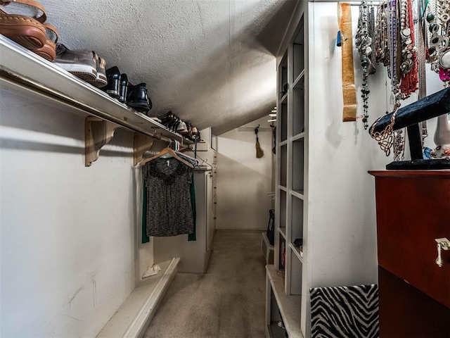 spacious closet featuring carpet flooring and vaulted ceiling